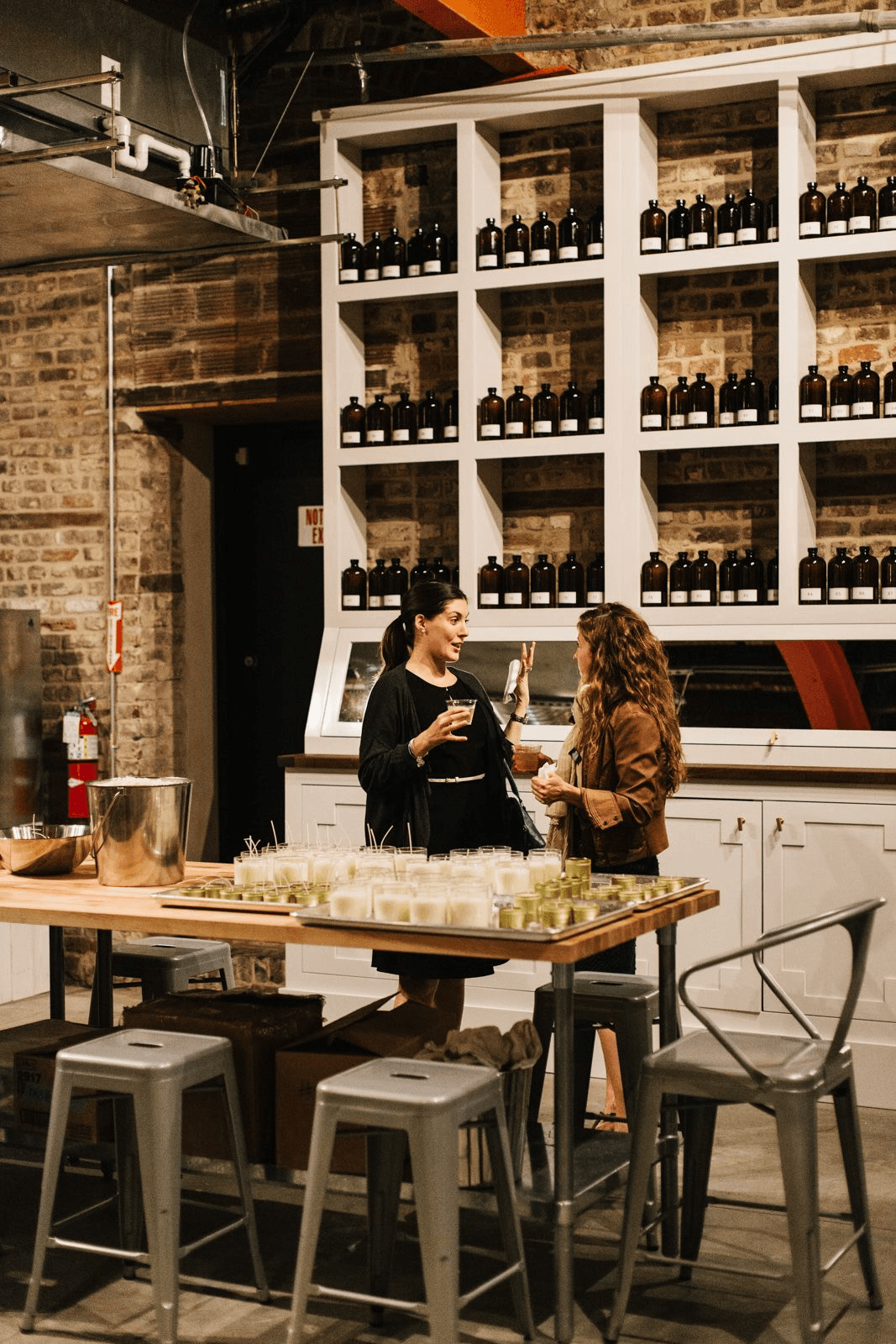 Artisan perfume workshop atmosphere, warm wood and glass bottles